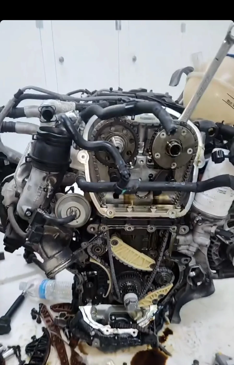 An engine with the timing cover off, a cam sprocket and chain tensioner showing